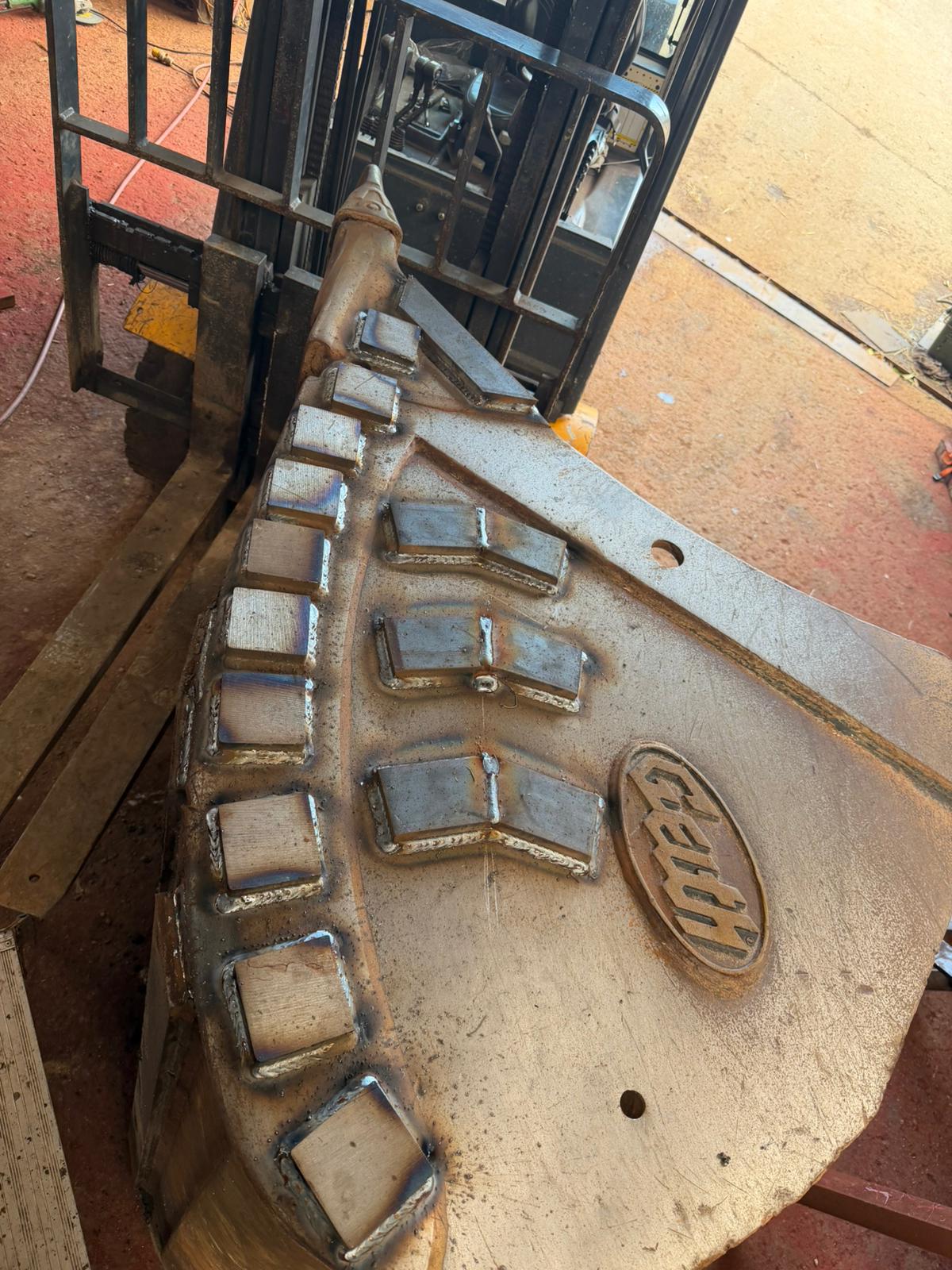 Welded digger bucket wear pads